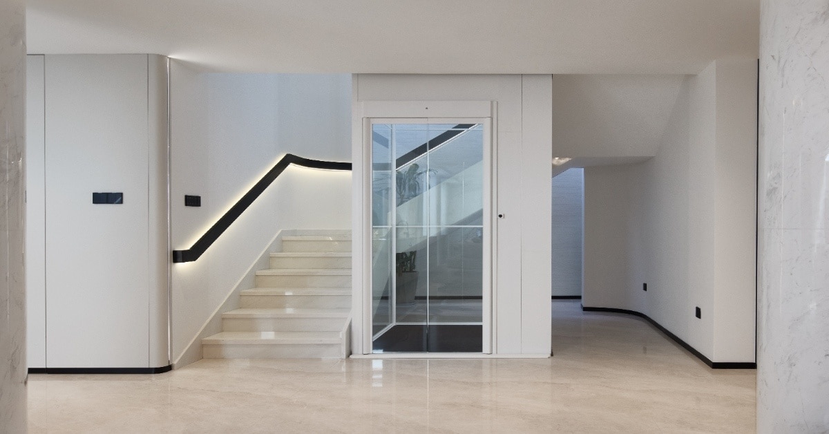Home comparison showing curved stairlift on staircase and through floor lift installation in a modern UK house for accessibility choice