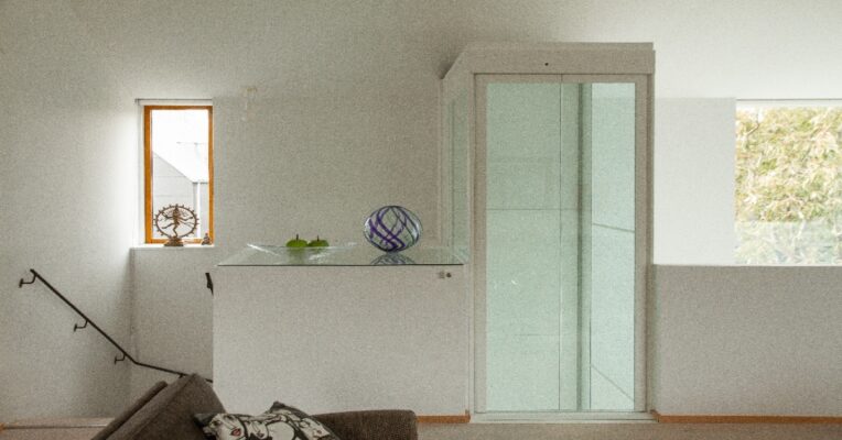 Compact home lift installed beside a staircase in an Indian home