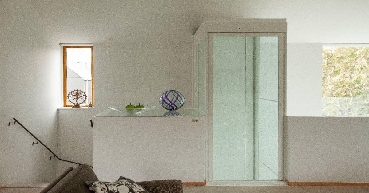 Compact home lift installed beside a staircase in an Indian home